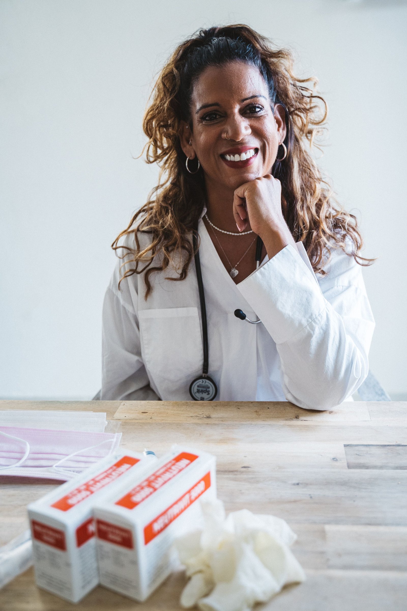 A clinician at a desk. The photograph is illustrative, not Sirius staff.