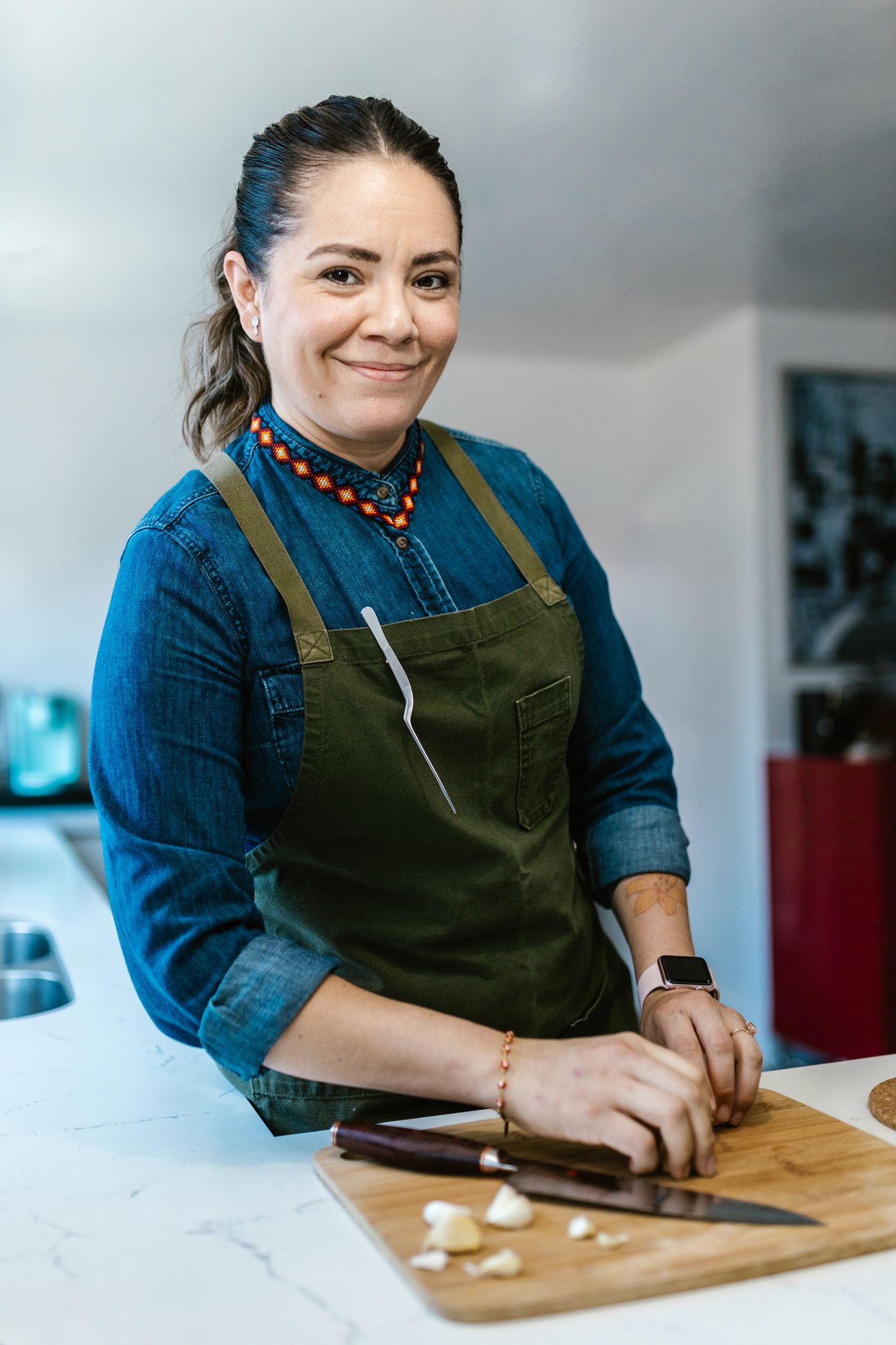 An adult preparing food in a kitchen
