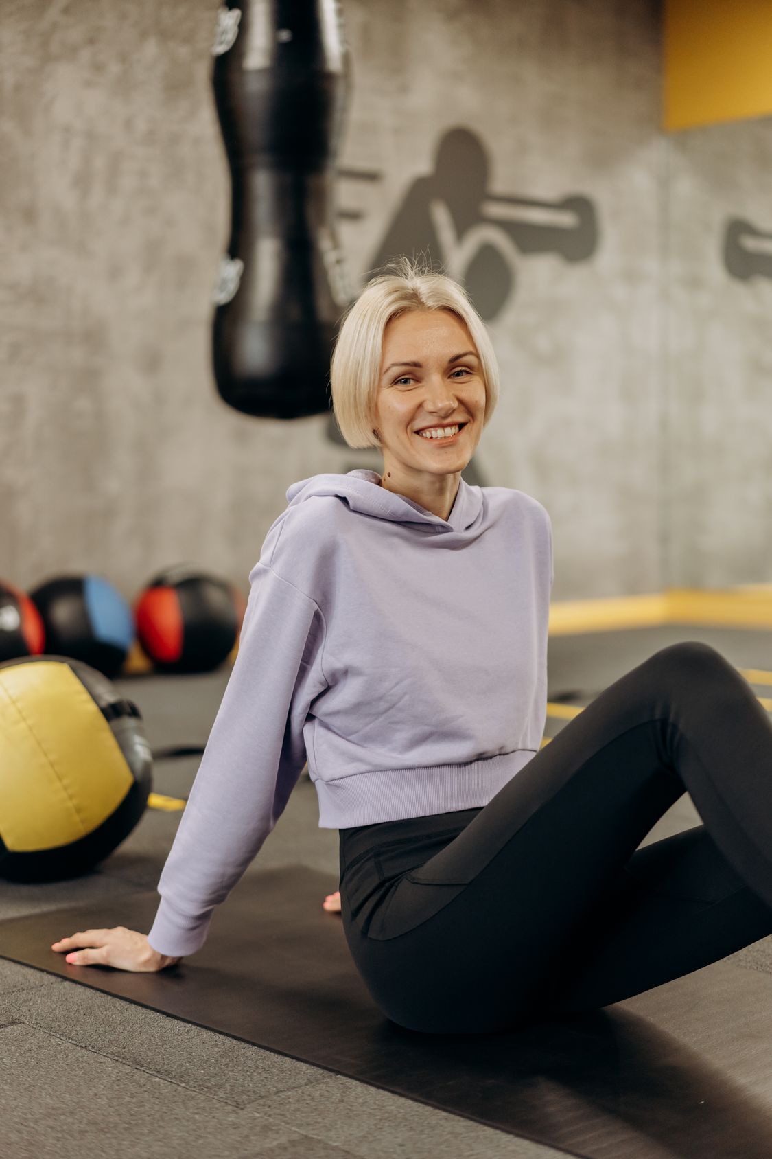 An adult stretching on an exercise mat